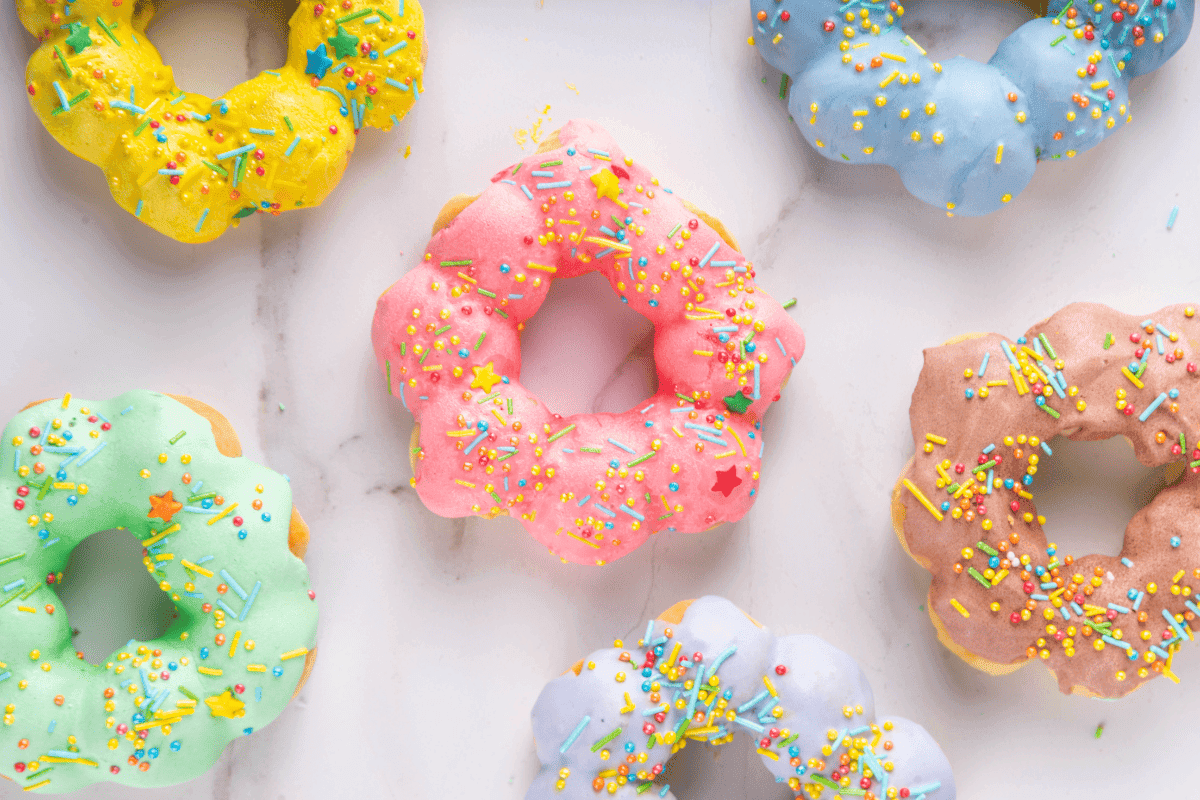 colourful flower shaped donuts decorated with sprinkles